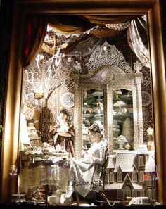 a display case with many glass items in it's front window at night time