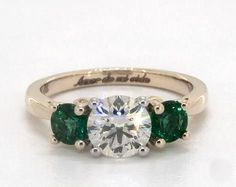 three stone diamond and emerald engagement ring