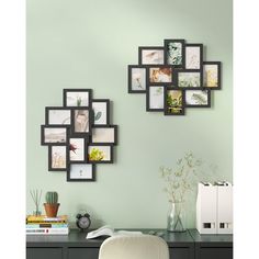 a desk with a chair and several pictures on the wall above it in black frames