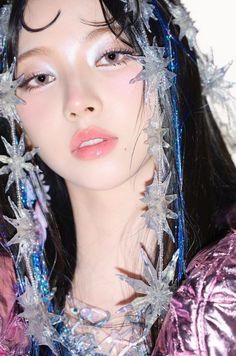 a close up of a person with snow flakes on her head