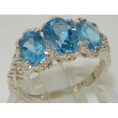 *This admirable ring is made from 925 Sterling Silver Gold with Natural Semi-precious Blue Topaz.*Total gem weight 3.4ctAn impressive Victorian / Antique Style Ring set with a center 8x6mm (0.32"x0.24" inches) & two 7x5mm (0.28"x0.20" inches) oval cut Blue Topaz in Solid 925 Sterling Silver Gold prong setting. This ring has a good solid feel, a nice weight and a good thick shank.*Total Height 5mm, Width 16mm, Length 11mm Made completely from Solid English Sterling Silver. This ring has been Formal Blue Topaz Three Stone Ring, Fine Jewelry Blue Topaz Three Stone Ring, Three-stone Blue Topaz Ring For Anniversary, Anniversary Three-stone Blue Topaz Ring, Blue Topaz Three Stone Ring For Anniversary, Three Stone Blue Topaz Ring For Anniversary, Anniversary Three-stone Topaz Jewelry, Three Stone Topaz Ring In Sterling Silver, Anniversary Three Stone Topaz Jewelry