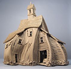 a wooden model of a church with a steeple on it's roof and windows