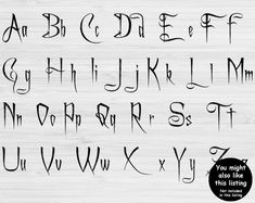 an old english alphabet with black ink on white wood