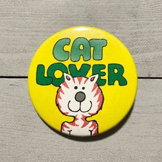 a yellow button that says cat lover with a white tiger on it's face