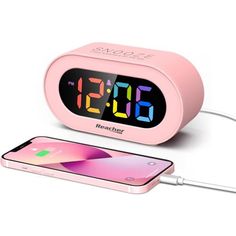 the alarm clock is connected to an iphone and charging charger with a usb cable