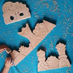 children are playing with wooden puzzles on the floor