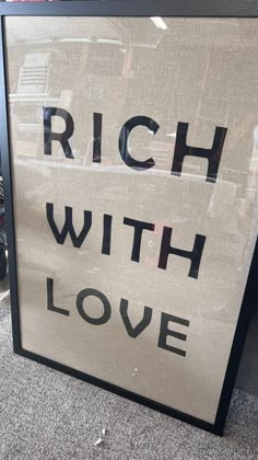 a sign that says rich with love on it