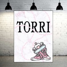 there is a sign that says torri with sneakers on it and the words torri written in black