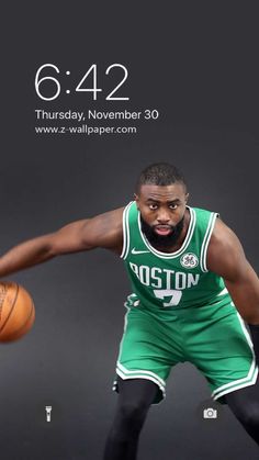 a man holding a basketball while standing next to an iphone screen with the boston logo on it