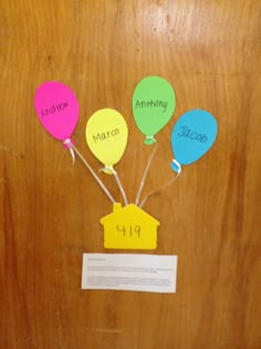 the door is decorated with colorful balloons and name tags