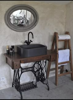 an old fashioned sewing machine sits next to a sink