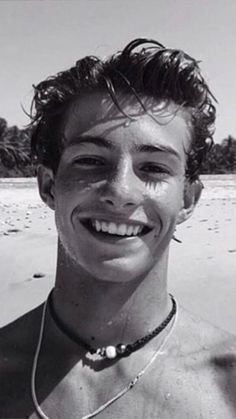 black and white photograph of man smiling on beach