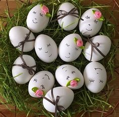 eggs with faces painted on them are arranged in a circle and tied to the grass