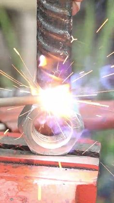 welder working on an object with sparks coming from it