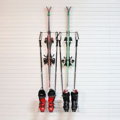 there are skis and snowboards hanging on the wall