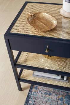 a tray with a wooden spoon on top of it next to a coffee cup and rug