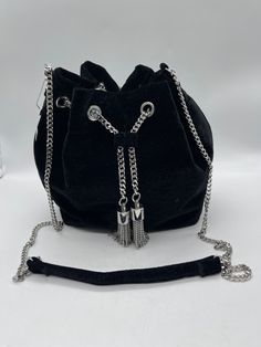 This stylish crossbody purse from White House Black Market is perfect for any occasion. The black velvet exterior and silver chain strap give it a chic and sophisticated look, while the spacious interior lined with black velvet provides ample room for all of your essentials. The versatile design makes it a great addition to any outfit, whether you're dressing up for a night out or running errands during the day. With its high-quality materials and United States craftsmanship, this purse is sure to be a favorite for years to come. The NWT (new with tags) condition ensures that you're getting a brand new product that has never been used. Don't miss out on this must-have accessory for any fashion-forward woman. Strap Purse, Crossbody Purse, Chain Strap, White House Black, White House Black Market, House Black, Black House, Black Velvet, Running Errands