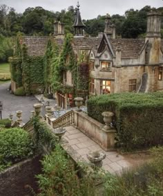 an old house with ivy growing on it's walls and stairs leading up to the front door