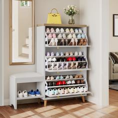 a white shoe rack filled with shoes next to a mirror