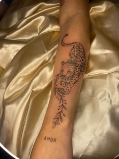 a woman's arm with a tattoo on it that reads, mom and an image of a cheetah