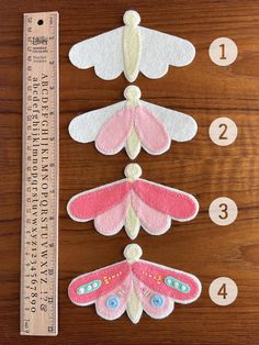 the instructions for how to make felt dragonflys on a wooden table with numbers