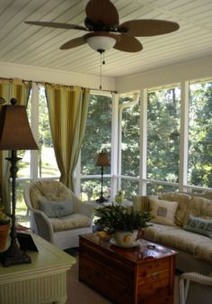 a living room filled with furniture and a ceiling fan