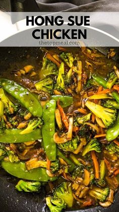 broccoli and carrots are being cooked in a wok