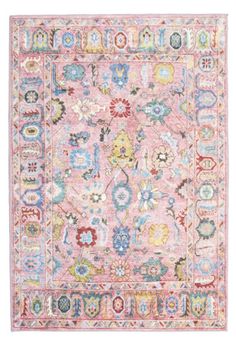 a pink rug with many different colors and designs on the front, along with an ornate border