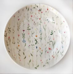 a white plate with flowers painted on it