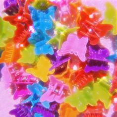 many different colored plastic hair clips in a pile