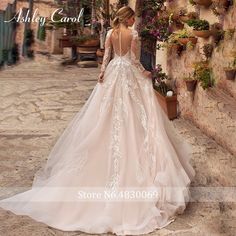 a woman in a wedding dress is walking down the street with her back to the camera