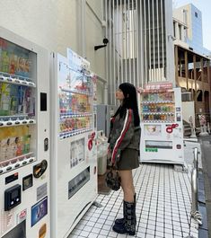 a woman standing in front of a vending machine