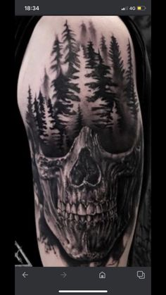 a black and white photo of a skull with trees on it's back shoulder