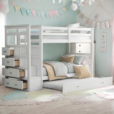 a white bunk bed with drawers underneath it in a room filled with furniture and decor