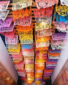 there are many colorful laces hanging from the ceiling