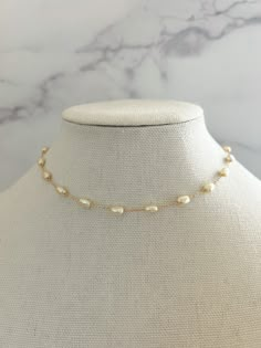 "Pearl Necklace - made from porcelain pearls, detailed on an 18k gold filled chain, and has an extender chain attached for different lengths.   This simple and dainty Pearl necklace is perfect for everyday wear- even into the night! Necklace length: 15 3/4\" with 2\" extender Porcelain Pearl Size: 4mm Material: 18k Gold Filled Chain" Minimalist Pearl Jewelry, Adjustable Gold Charm Necklace With Pearl Chain, Adjustable Gold Pearl Charm Necklace, Gold Charm Necklace With Pearl Chain And Adjustable Fit, Adjustable Gold Pearl Charm Necklaces, Delicate Single Strand Gold Chain Necklace, Yellow Gold Baroque Pearl Jewelry With Adjustable Chain, Gold Pearl Jewelry With Beaded Chain, Adjustable Gold Charm Necklace With Pearl Pendant