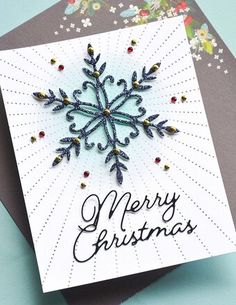 a christmas card with a snowflake on it