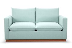 a light blue couch with two pillows on it