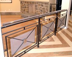 an empty living room with stone fireplace and metal railings on the floor, in front of a brick wall