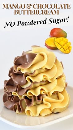 mango and chocolate buttercream no poached sugar on a white plate next to sliced mangoes