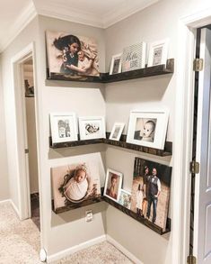 three shelves with pictures on them in the corner of a room next to a door