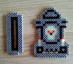 two pieces of bead art made to look like legos, one with a robot on it