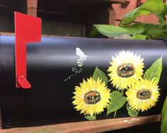 a mailbox with sunflowers painted on it