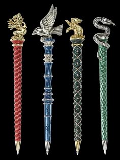 four different colored pens with dragon and snake on them