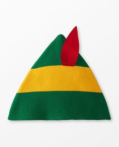 a green, yellow and red knitted hat on a white surface with a red tip