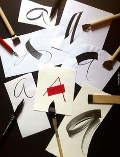 several pieces of paper with different shapes and sizes on them next to some pencils