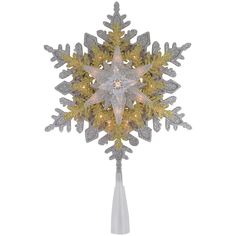 a lighted snowflake on a white background with gold and silver decorations in the center