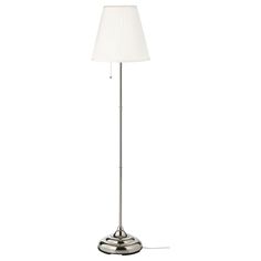 a floor lamp with a white shade on it