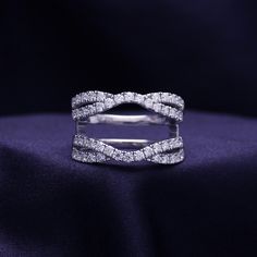 a diamond ring on top of a purple cloth