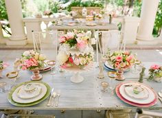 the table is set with white flowers and wine glasses